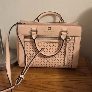 A light pink Kate Spade crossbody bag with gold hardware & applique detailing